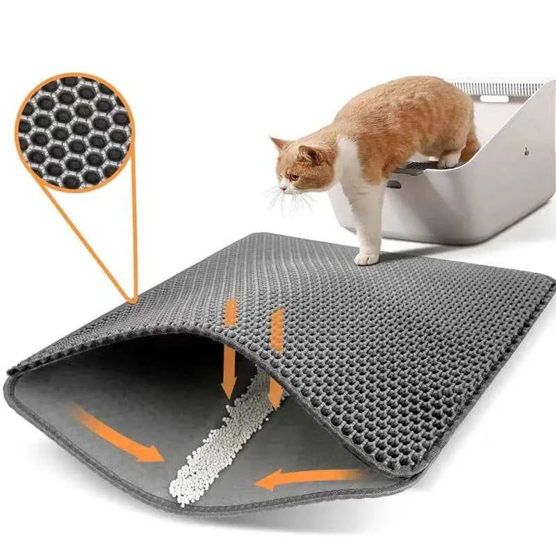 A cat beside a litter box and a double-layer litter mat.